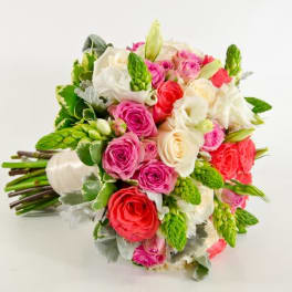 Bouquet of pink, red, and white roses with green accents
