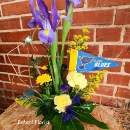 Purple irises with yellow and blue flowers in a low arrangement