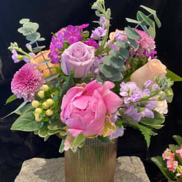 Pink and lavender bouquet in a ribbed glass vase
