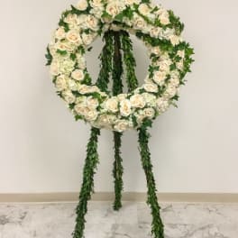 White rose funeral wreath on a standing easel