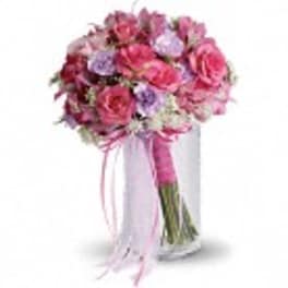 Pink and lavender bouquet with ribbon in a clear vase