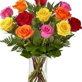 Bouquet of multicolored roses in a clear glass vase