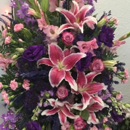 Tall pink and purple floral spray with lilies and roses