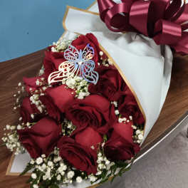 Bouquet of red roses with baby's breath in white wrapping