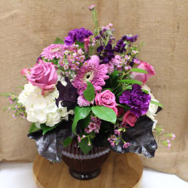Pink and purple mixed bouquet in a glass vase