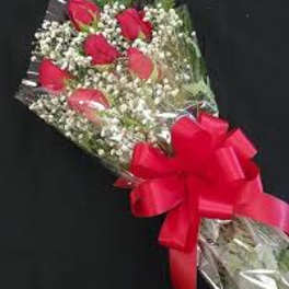 Bouquet of red roses with baby's breath and a red ribbon
