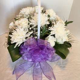 White floral basket arrangement with a purple ribbon bow