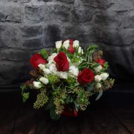 Bouquet of red and white roses with greenery