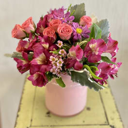Pink and magenta bouquet in a pale pink vase