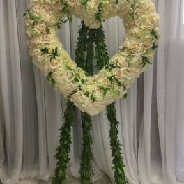 Heart-shaped floral standing arrangement with cream roses and hydrangeas