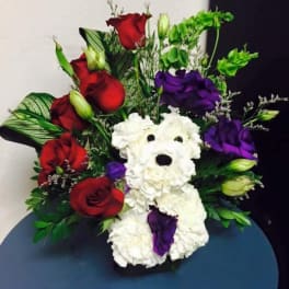 Bouquet with red and purple roses and a white teddy bear made of flowers
