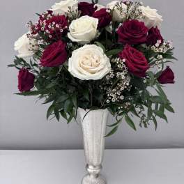 Bouquet of white and deep pink roses in a silver vase