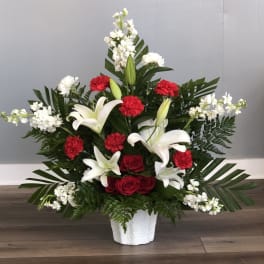 White lilies and red roses in a white vase