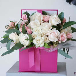 Pink and white rose bouquet in a bright pink gift box