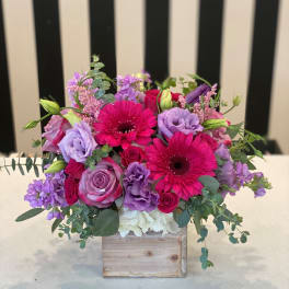 Pink and purple bouquet in a wooden box