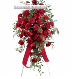 Red rose standing spray on an easel with ribbon
