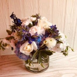 Bouquet of white and blue flowers in a glass vase