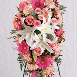 Pink and white floral standing spray with lilies, roses, and gerbera daisies