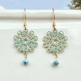 Pair of dangling floral earrings with blue beads