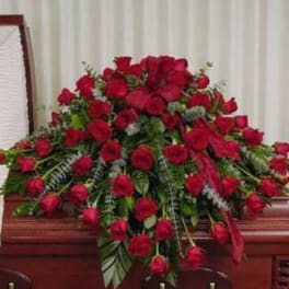 Large spray of red roses on a casket