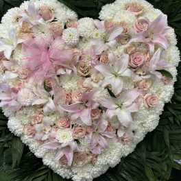 Heart-shaped floral arrangement with pink roses and white lilies