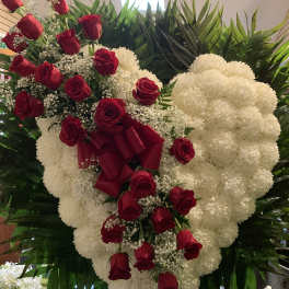 Heart-shaped floral spray with red roses and white flowers