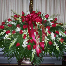 Large red rose casket spray with white flowers and ribbon
