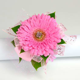 Pink gerbera daisy corsage with glitter and pink ribbons