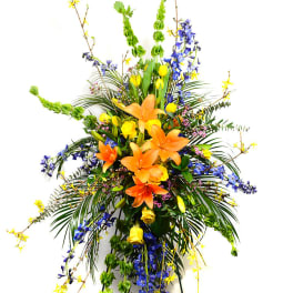 Tall floral spray with orange lilies and blue and yellow flowers
