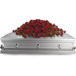 Red rose casket spray on a silver casket