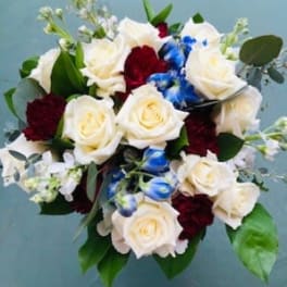 Bouquet of white roses, red carnations, and blue flowers