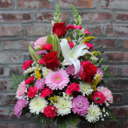 Mixed bouquet with red roses, white lilies, and pink daisies