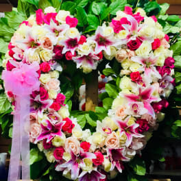 Heart-shaped floral wreath with pink and white roses and lilies