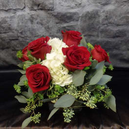Bouquet of red roses and white hydrangea with greenery