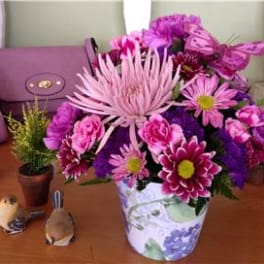 Pink and purple mixed bouquet in a floral ceramic vase