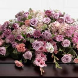 Lavender and pink floral casket spray with roses and carnations