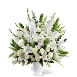 White floral arrangement in a white pedestal vase