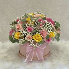 Pink hatbox arrangement with roses, carnations, and baby's breath