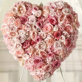 Heart-shaped arrangement of pink and blush roses