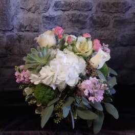 Bouquet of white hydrangeas, pink roses, and succulents