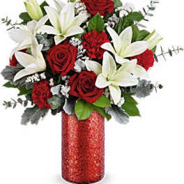 Red roses and white lilies arranged in a red vase
