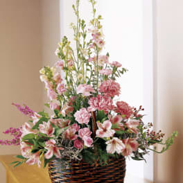Pink and white mixed flowers in a wicker basket