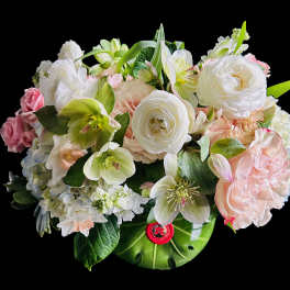 Pastel bouquet of white and pink flowers in a green vase