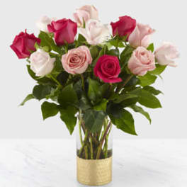 Bouquet of pink and white roses in a clear glass vase