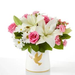 Pink roses and white lilies in a white vase with a gold dove design