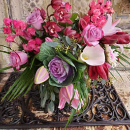Mixed bouquet with pink roses, orchids, calla lilies, and purple cabbage
