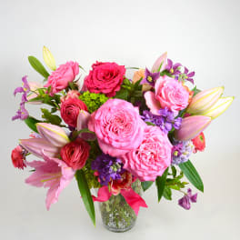 Pink and purple mixed bouquet in a clear glass vase