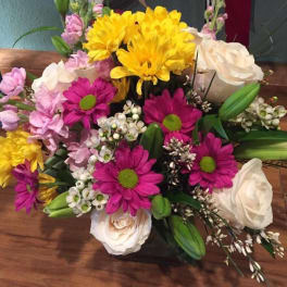 Mixed bouquet of yellow, pink, and white flowers