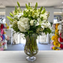 White floral arrangement in a clear glass vase