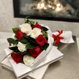 Bouquet of red and white roses wrapped in white paper